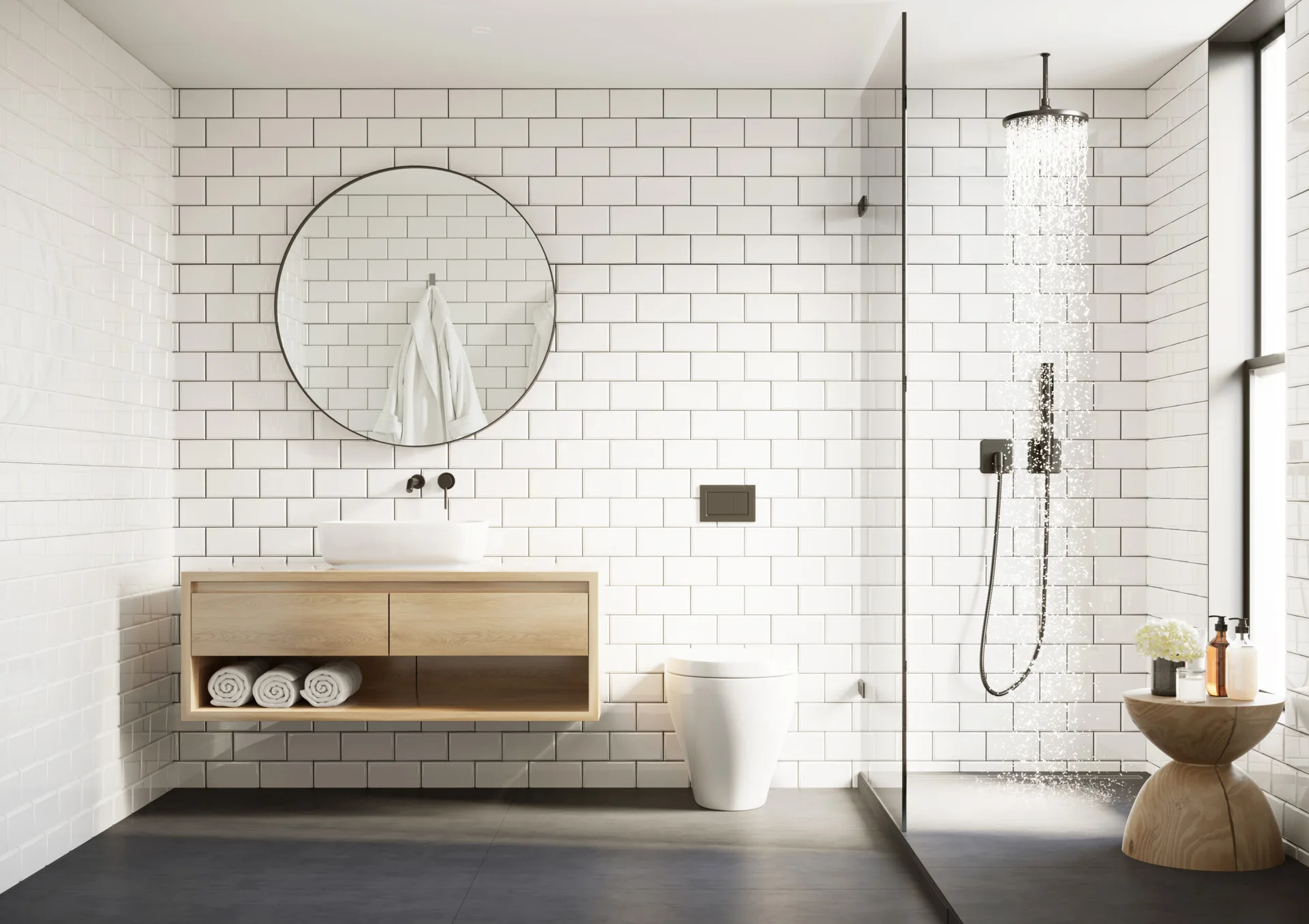 A minimalist bathroom features white subway tiled walls, a light wood floating vanity with a round mirror, and a walk-in shower with black fixtures.