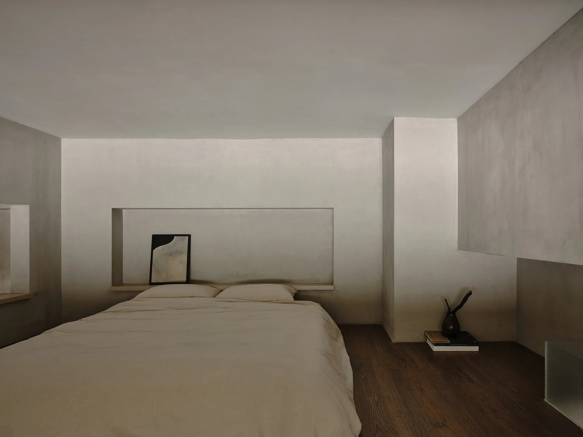 A low minimalist bed with beige linen rests against a plastered wall featuring a long horizontal recessed niche with a small framed artwork.