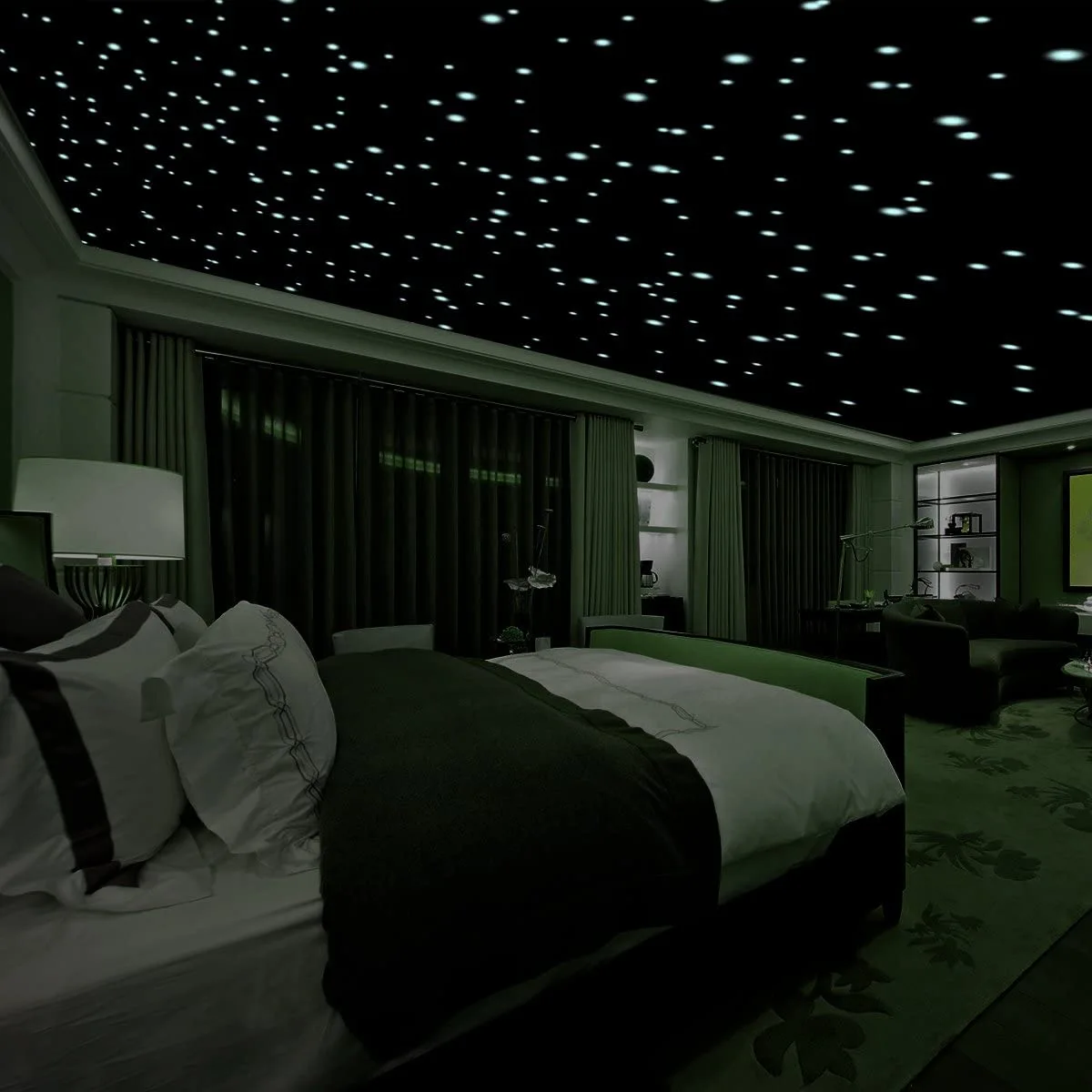 A dark green bedroom features a bed with white bedding, heavy curtains, and a black ceiling with pinpoint lights mimicking a starry night sky.