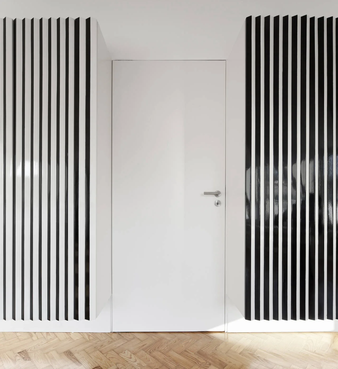 A flush white interior door with a silver handle is flanked by high-contrast black and white vertical slatted panels above a herringbone wood floor.