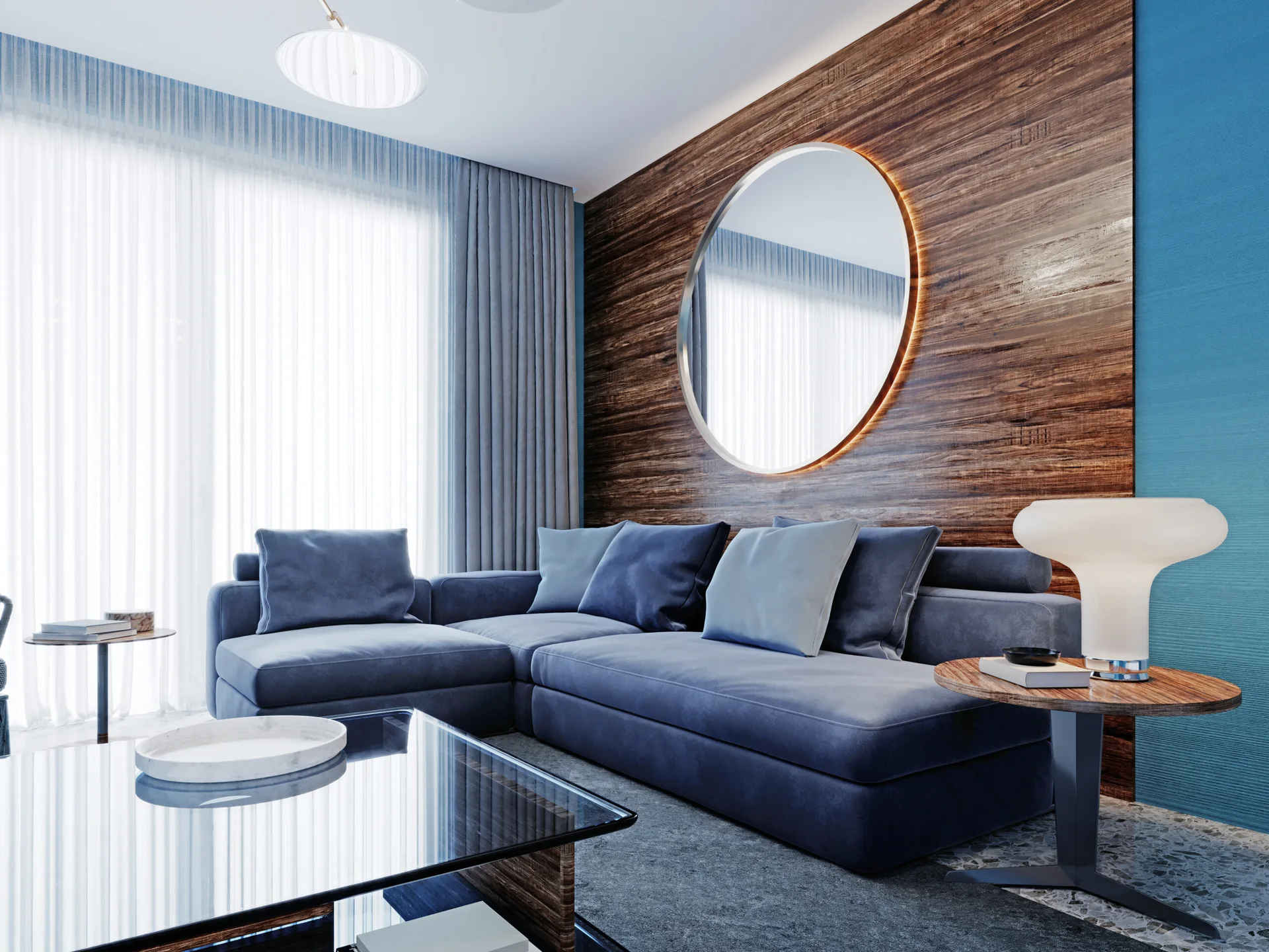 A blue sectional sofa is positioned against a horizontal wood-paneled accent wall featuring a large, backlit circular mirror in a modern living room.