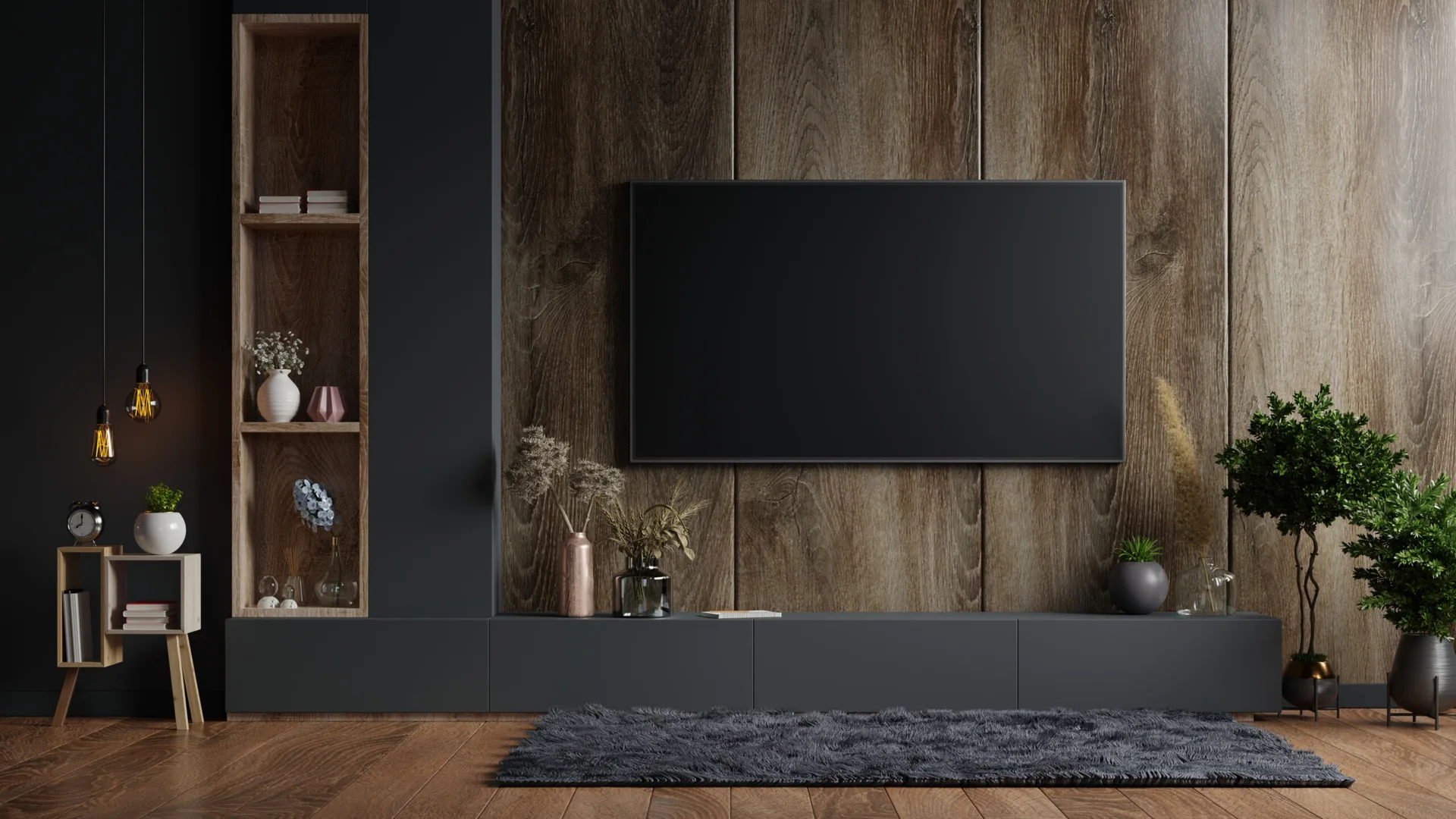 A contemporary media wall features a television mounted on vertical wood panels above a long dark grey console and next to built-in shelving.