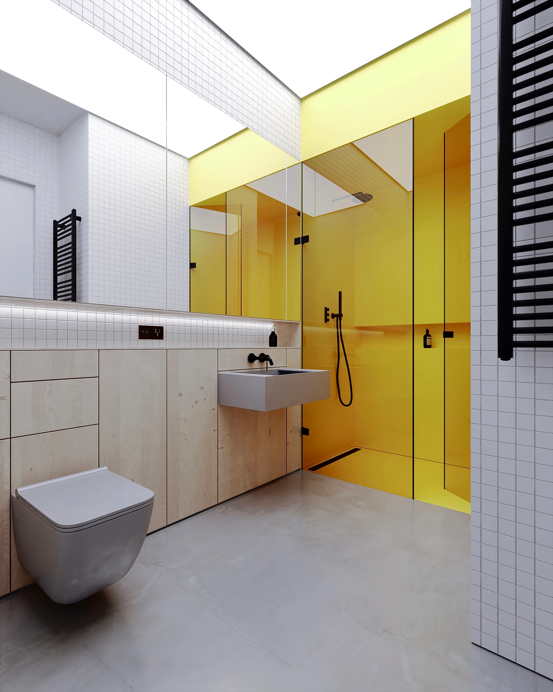 A modern bathroom features a bright yellow glass shower enclosure, a light wood vanity, a wall-mounted grey toilet, and white grid-tiled walls.