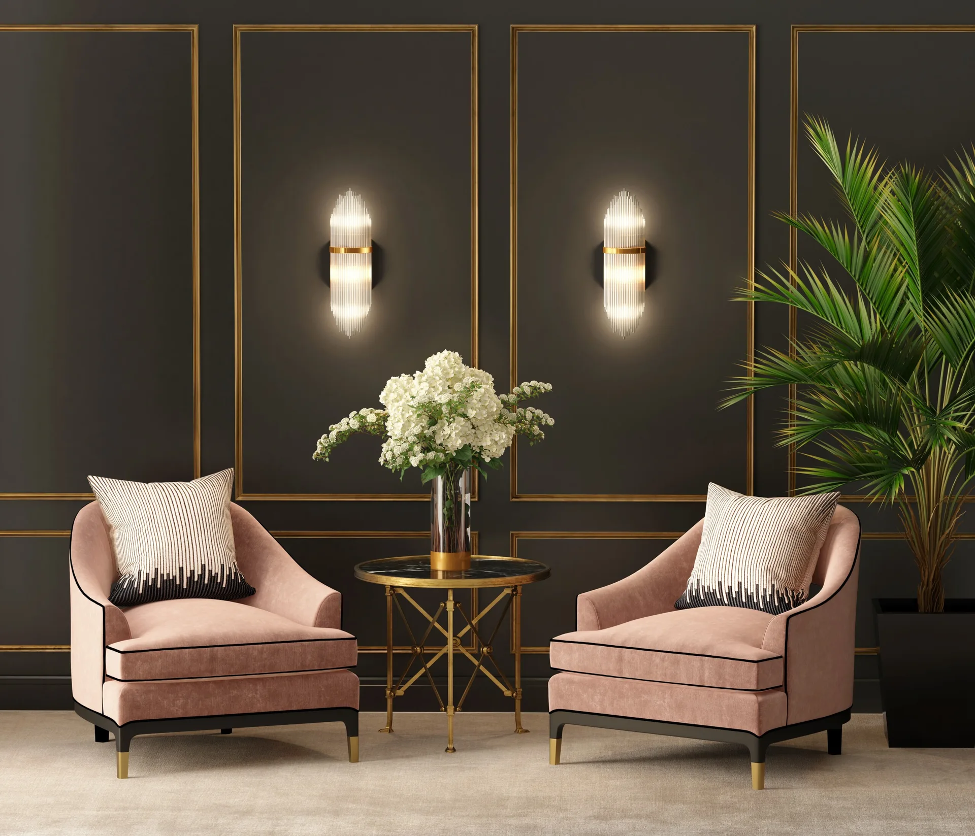 Two pink armchairs with striped pillows face a small gold table against a dark grey paneled wall featuring glowing gold sconces.