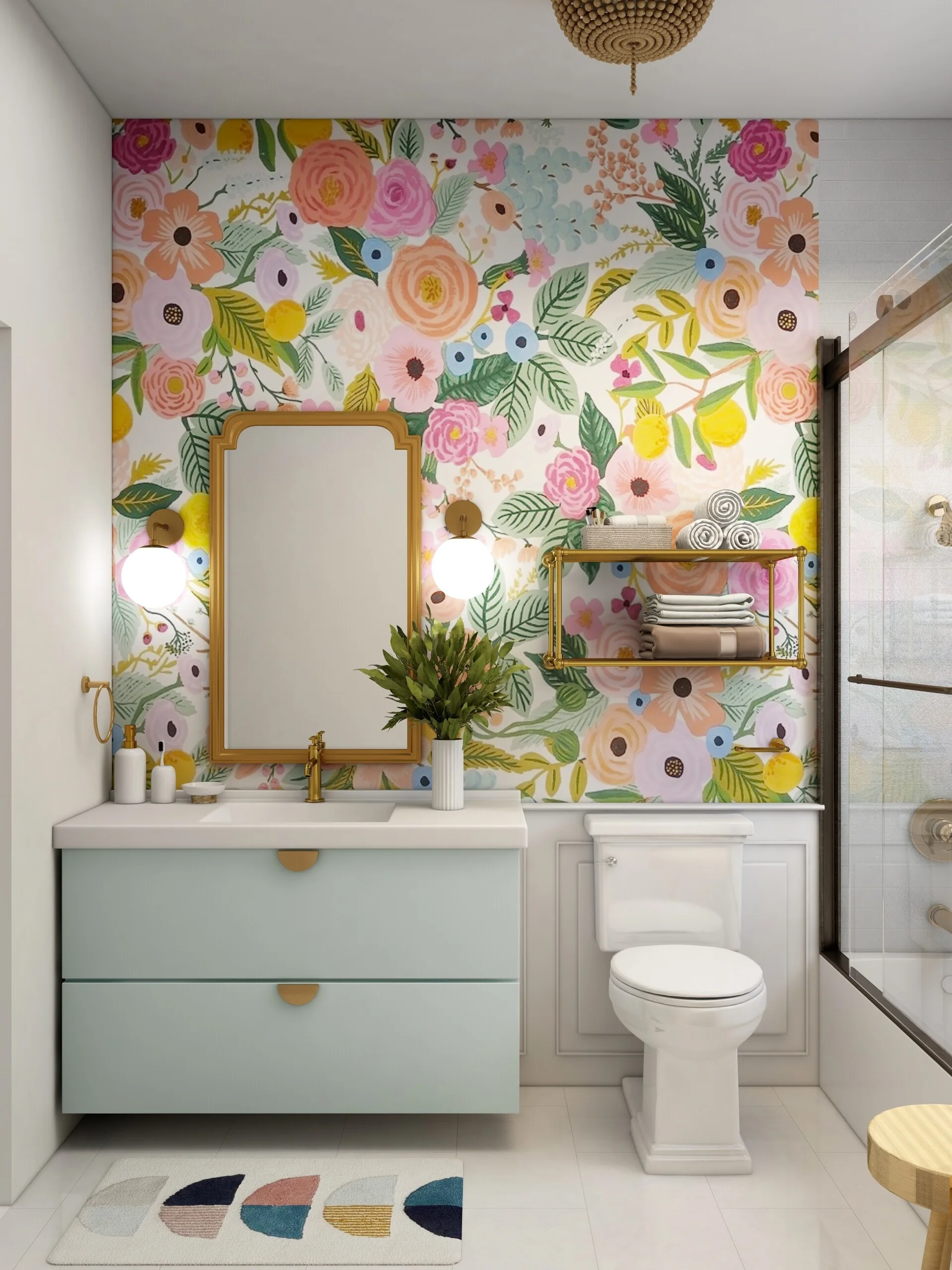 A modern bathroom features a light blue floating vanity under a gold mirror, set against colorful floral wallpaper and white wainscoting.