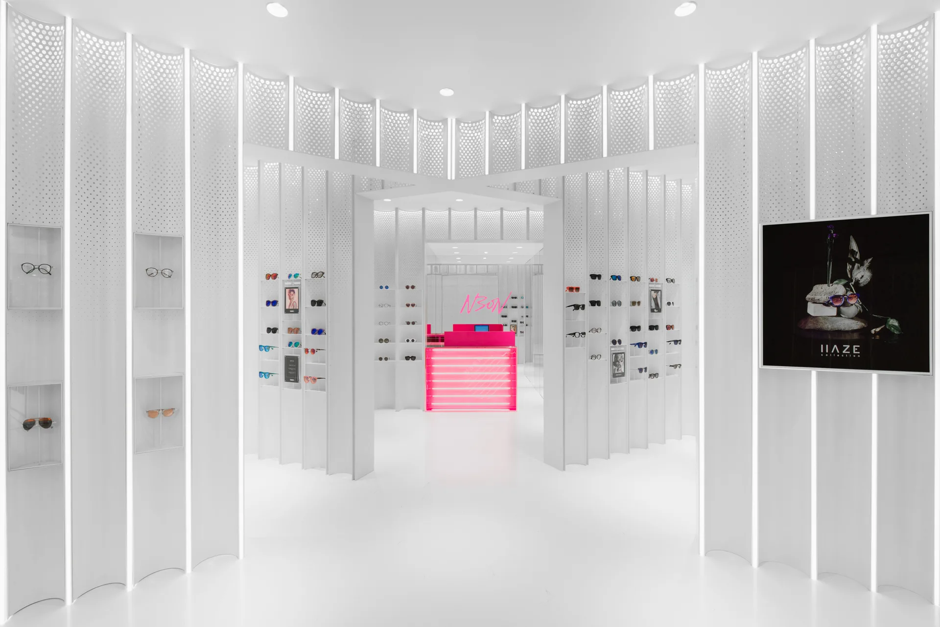 A futuristic retail store interior with curved white perforated wall panels, built-in eyewear shelves, and a glowing hot pink checkout counter.