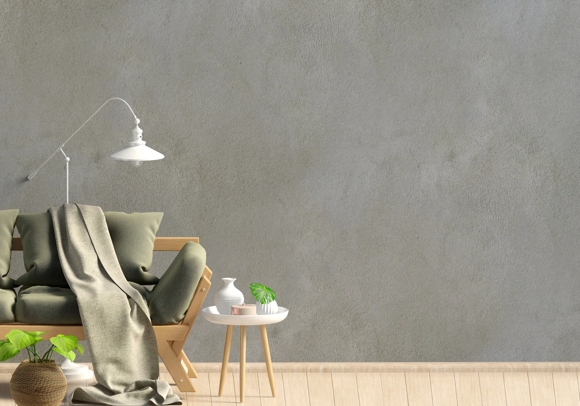 An olive green sofa with a beige throw blanket stands next to a white side table against a textured grey stucco wall on light wood floors.
