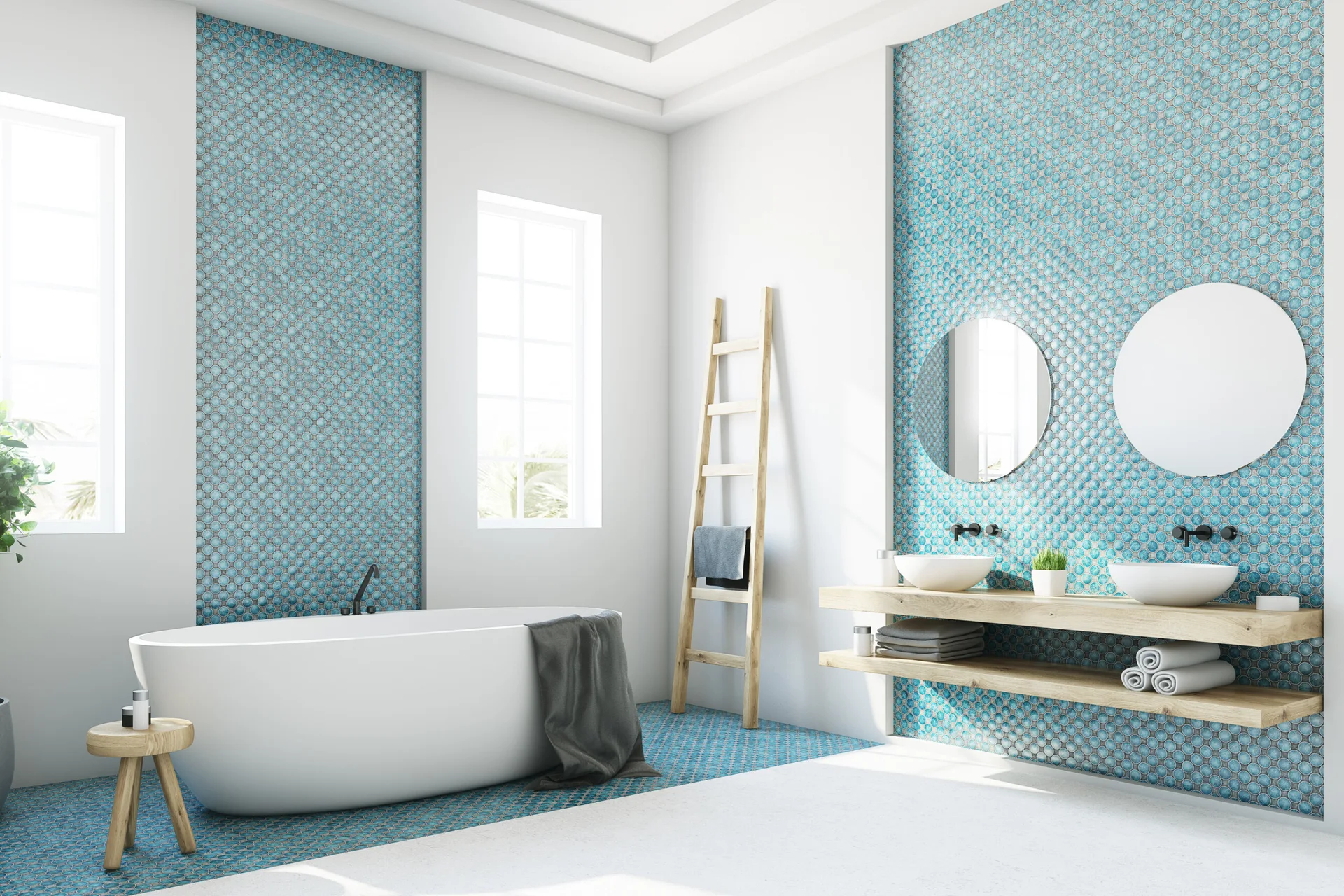 A modern bathroom features a white freestanding bathtub, dual vessel sinks on a wooden floating vanity, and blue penny tile accent walls.