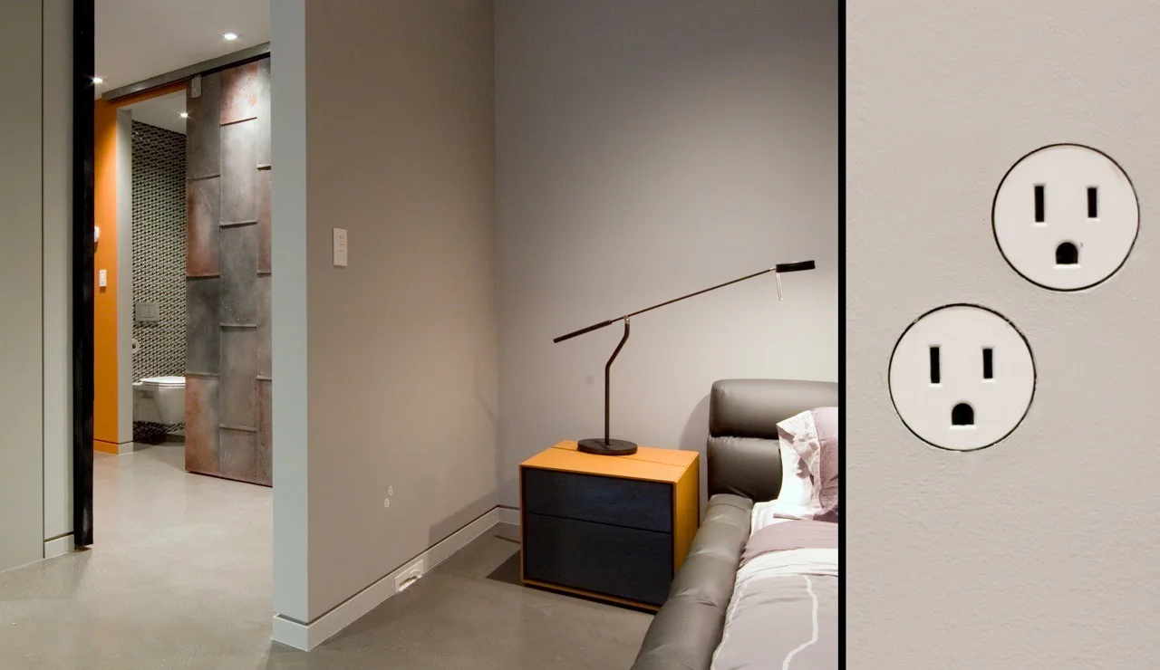 A modern grey bedroom with a two-tone nightstand next to an upholstered bed, featuring a split-screen detail of flush circular electrical outlets.