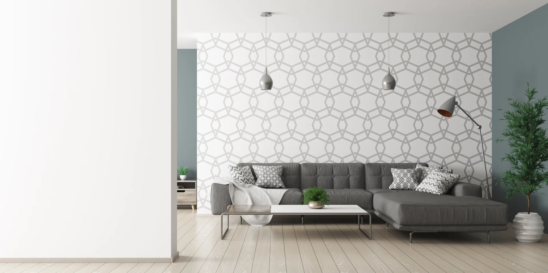 A modern living room features a grey sectional sofa against a geometric patterned accent wall, with light wood floors and metallic pendant lights.