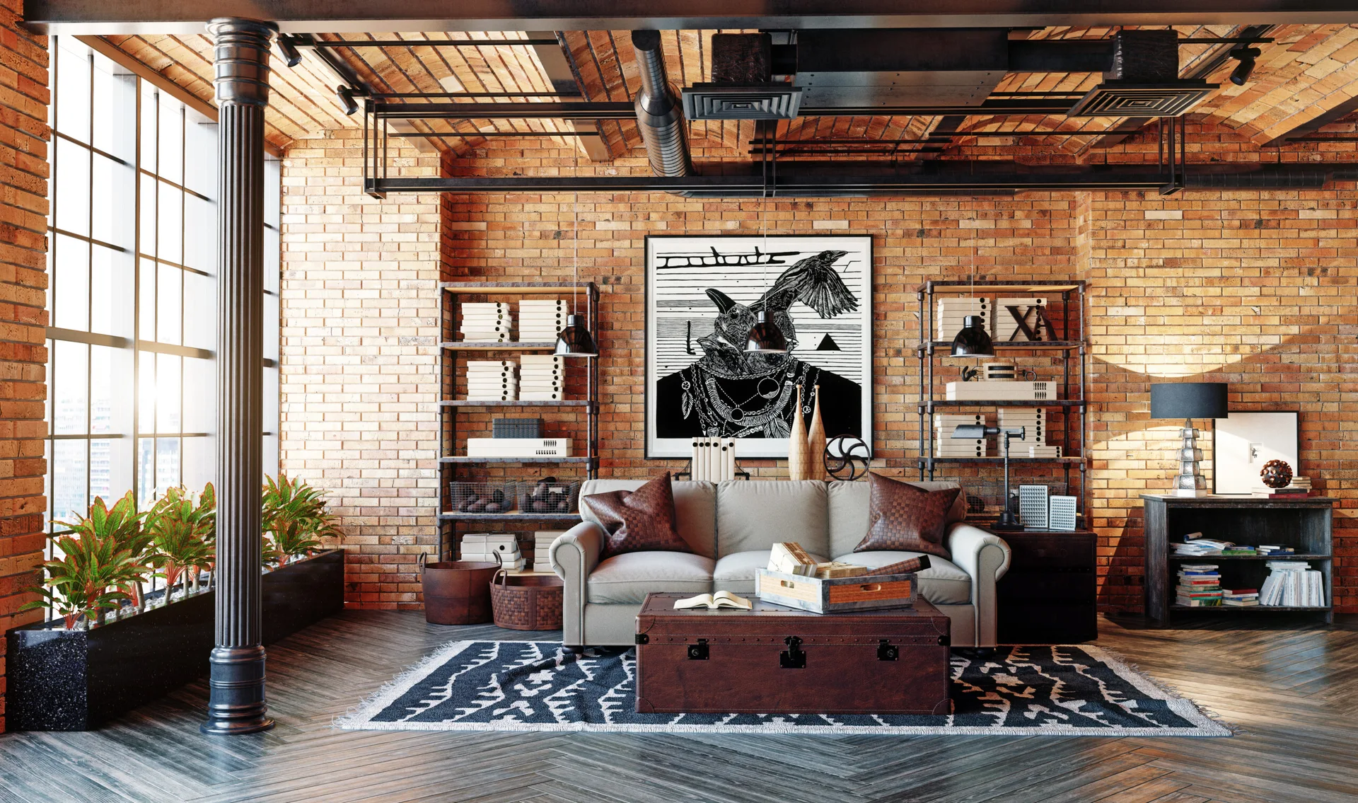An industrial loft living room features a grey sofa, a leather trunk coffee table, twin metal bookshelves, and exposed red brick walls.