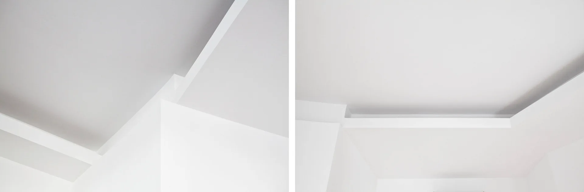 Close-up detail of a minimalist white ceiling featuring a stepped recessed drywall corner and clean painted surfaces.