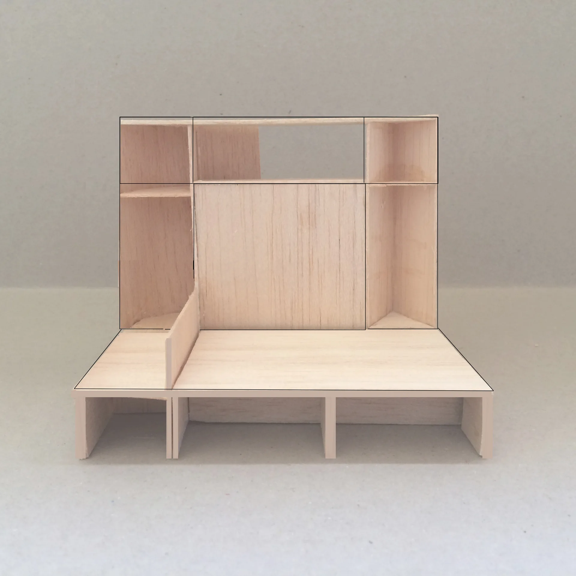 A balsa wood architectural scale model of a custom wall shelving unit featuring multiple compartments and platforms on a neutral background.