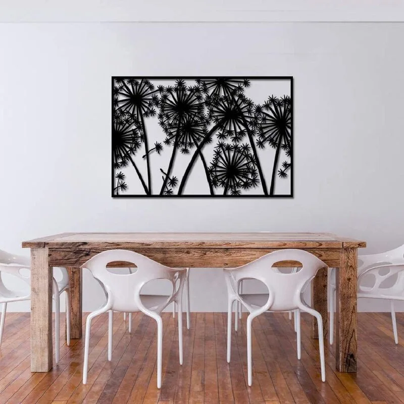A modern dining room features a rustic wood table paired with white molded plastic chairs and a large black metal dandelion silhouette wall hanging.