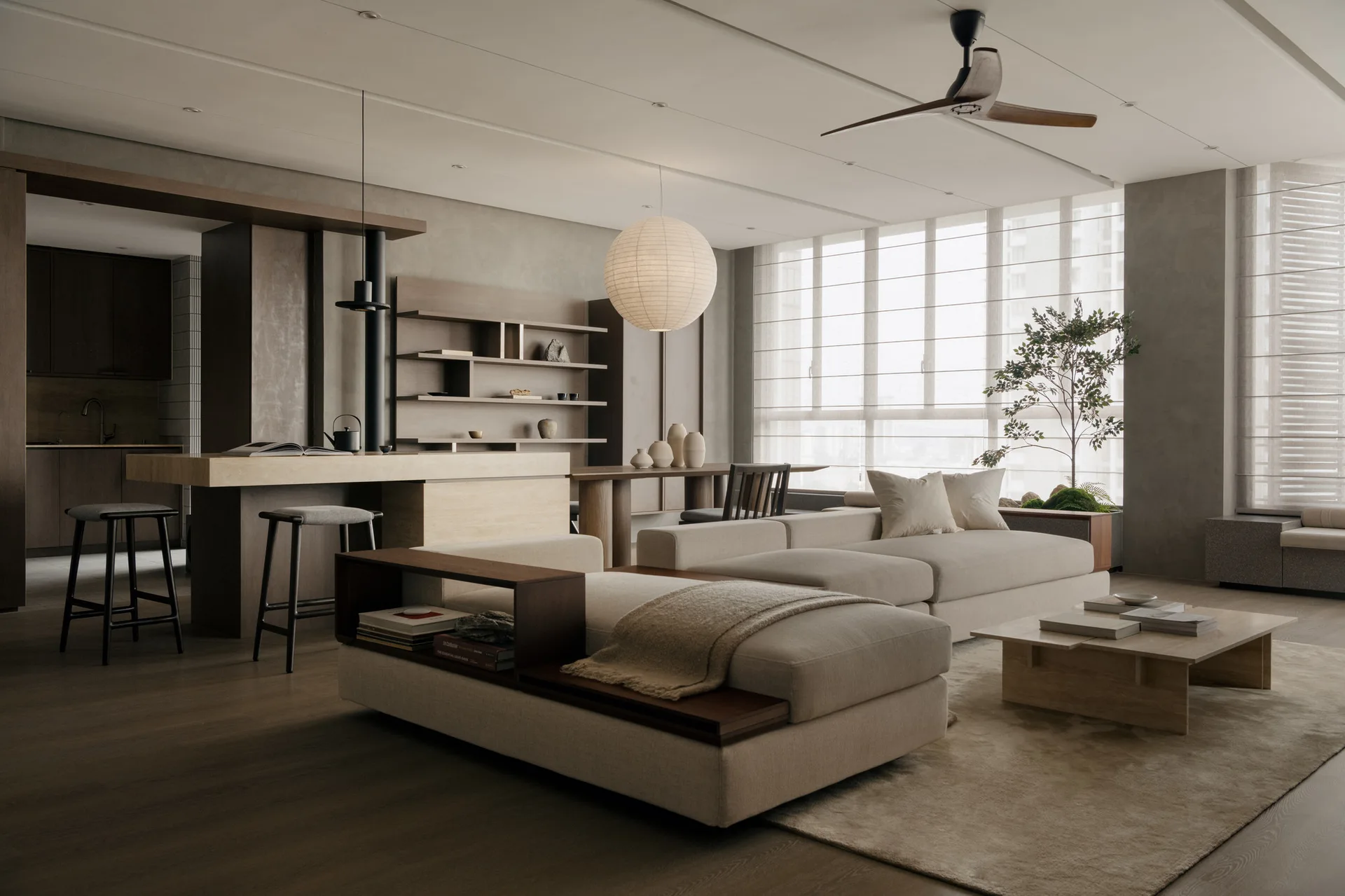 A minimalist Japandi living room featuring a cream sectional sofa with built-in wooden shelving, a low wooden coffee table, and a paper globe pendant light.