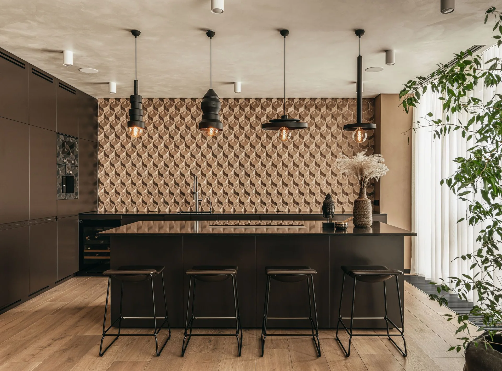 A modern kitchen features a dark brown island with four bar stools, industrial pendant lights, and a textured geometric tile backsplash.