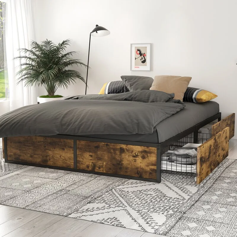 A black metal platform bed with industrial wood-toned storage drawers sits on a patterned geometric rug in a bright bedroom.
