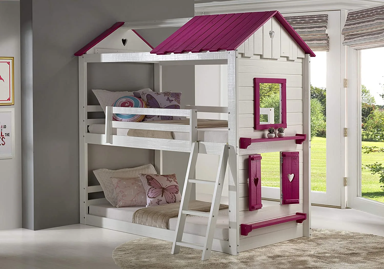 A two-tier children's wooden bunk bed designed like a playhouse with a white frame, magenta roof, small window shutters, and a ladder.