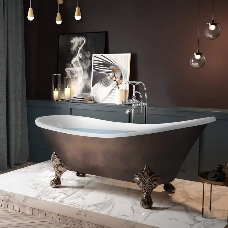 A bronze-toned clawfoot bathtub sits on a white marble platform in a dimly lit bathroom with dark gray paneled walls.