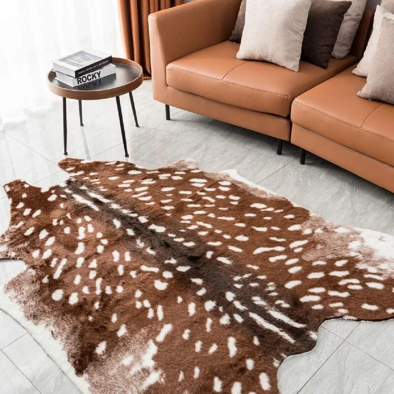 A spotted brown and white fawn print area rug sits on grey tile flooring next to a tan leather sofa and a small round side table.