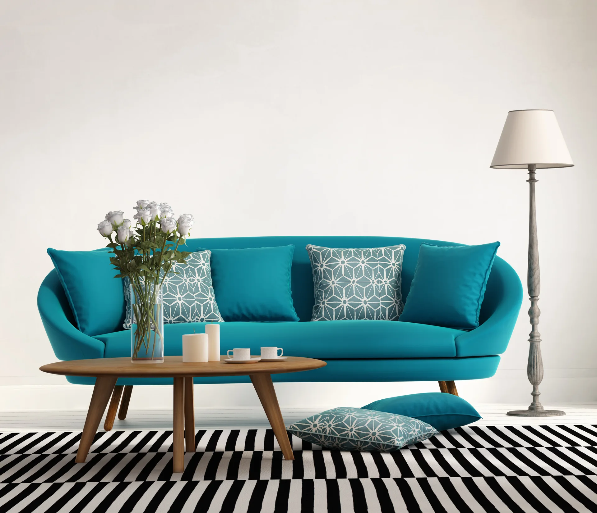 A curved turquoise sofa sits on a bold black and white striped rug next to a round wooden coffee table and a grey floor lamp.
