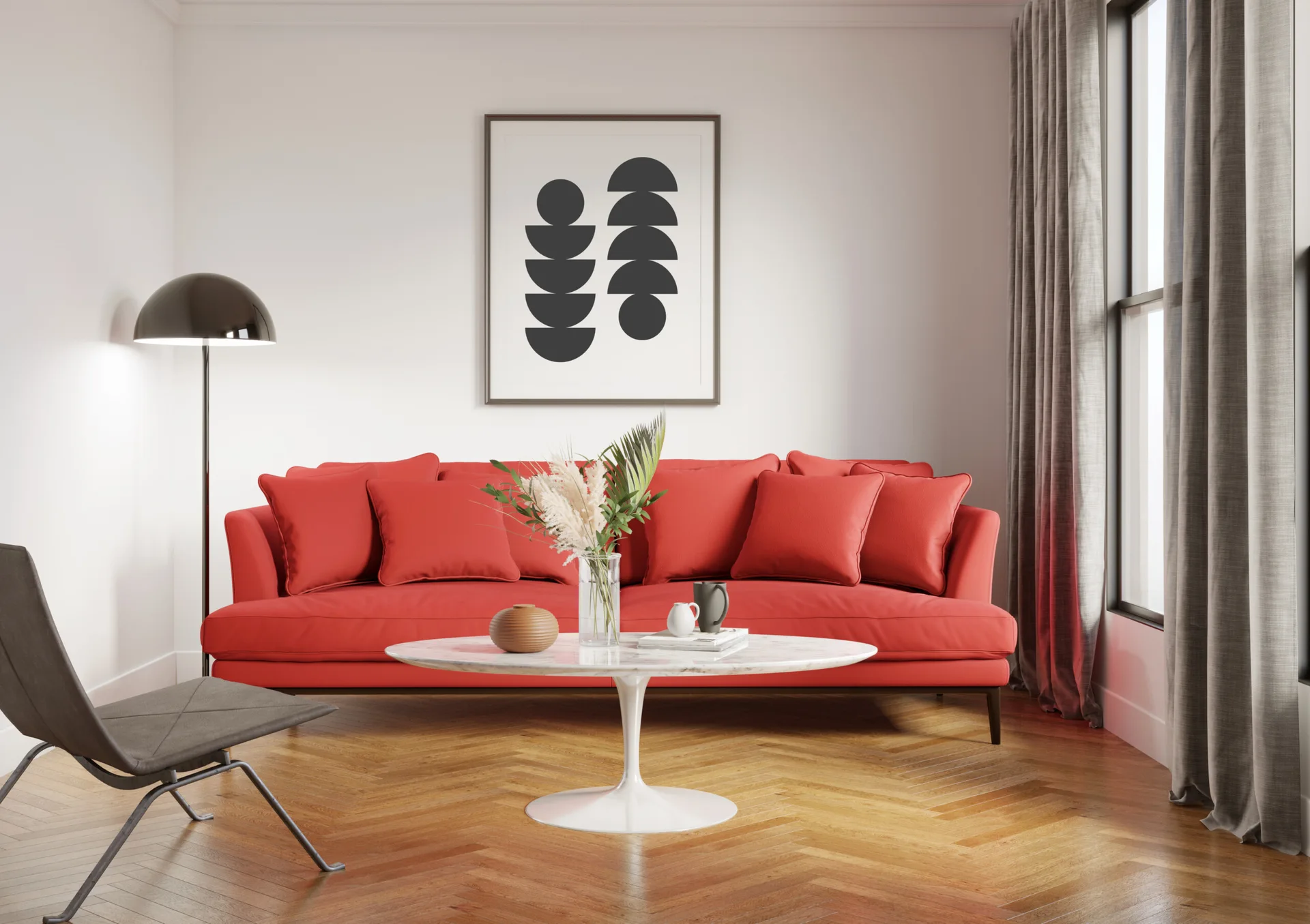 A modern living room featuring a bright red sofa, a marble pedestal coffee table, herringbone wood floors, and minimalist wall art.
