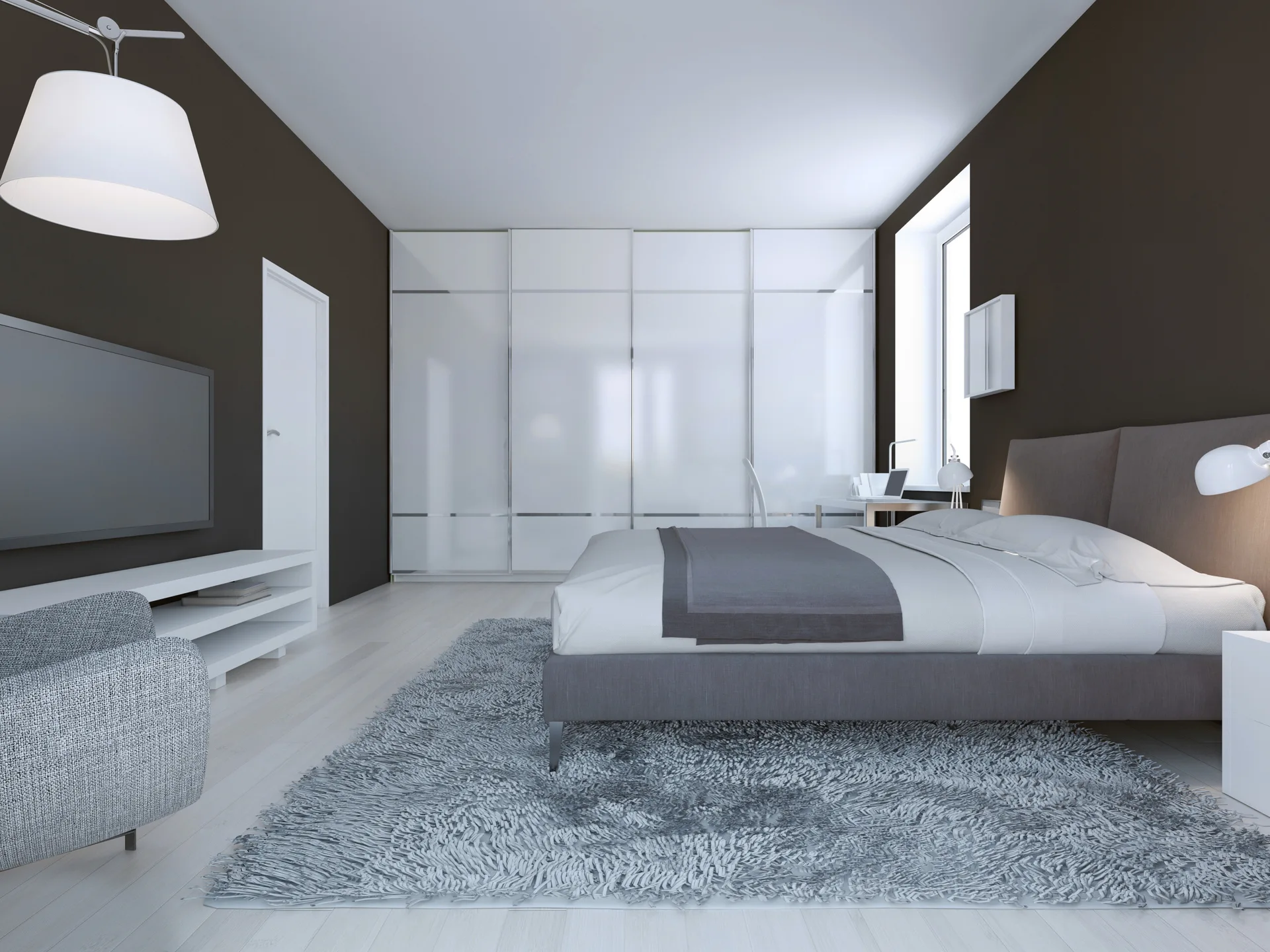 A contemporary bedroom features dark brown walls, a gray upholstered bed on a plush shag rug, and a large white built-in wardrobe.