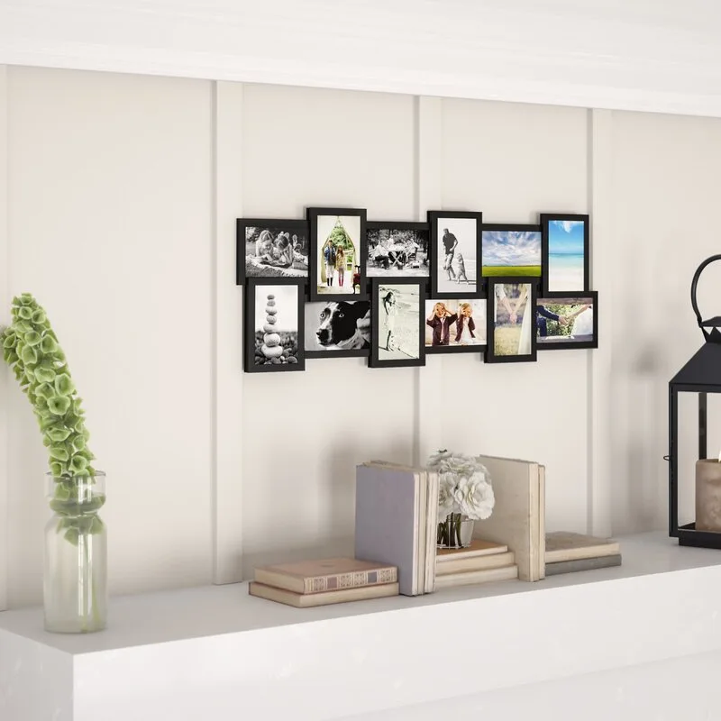 A black multi-photo collage frame hangs on a cream-colored paneled wall above a white mantel decorated with books, flowers, and a black lantern.