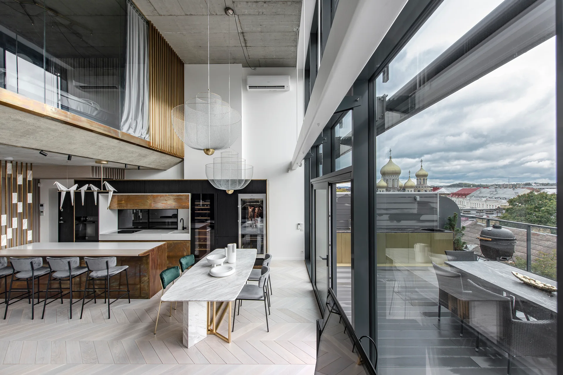 An open-concept kitchen and dining area features an exposed concrete ceiling, a marble table, mesh pendant lights, and floor-to-ceiling windows.