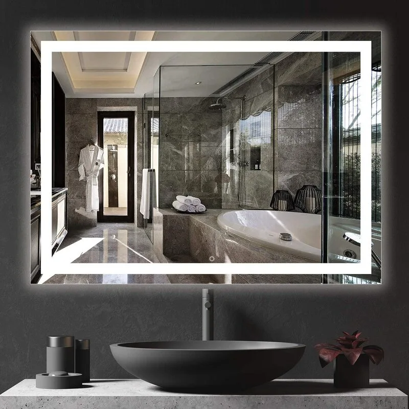 A modern rectangular backlit LED mirror hangs above a dark vessel sink and a textured concrete bathroom vanity countertop.