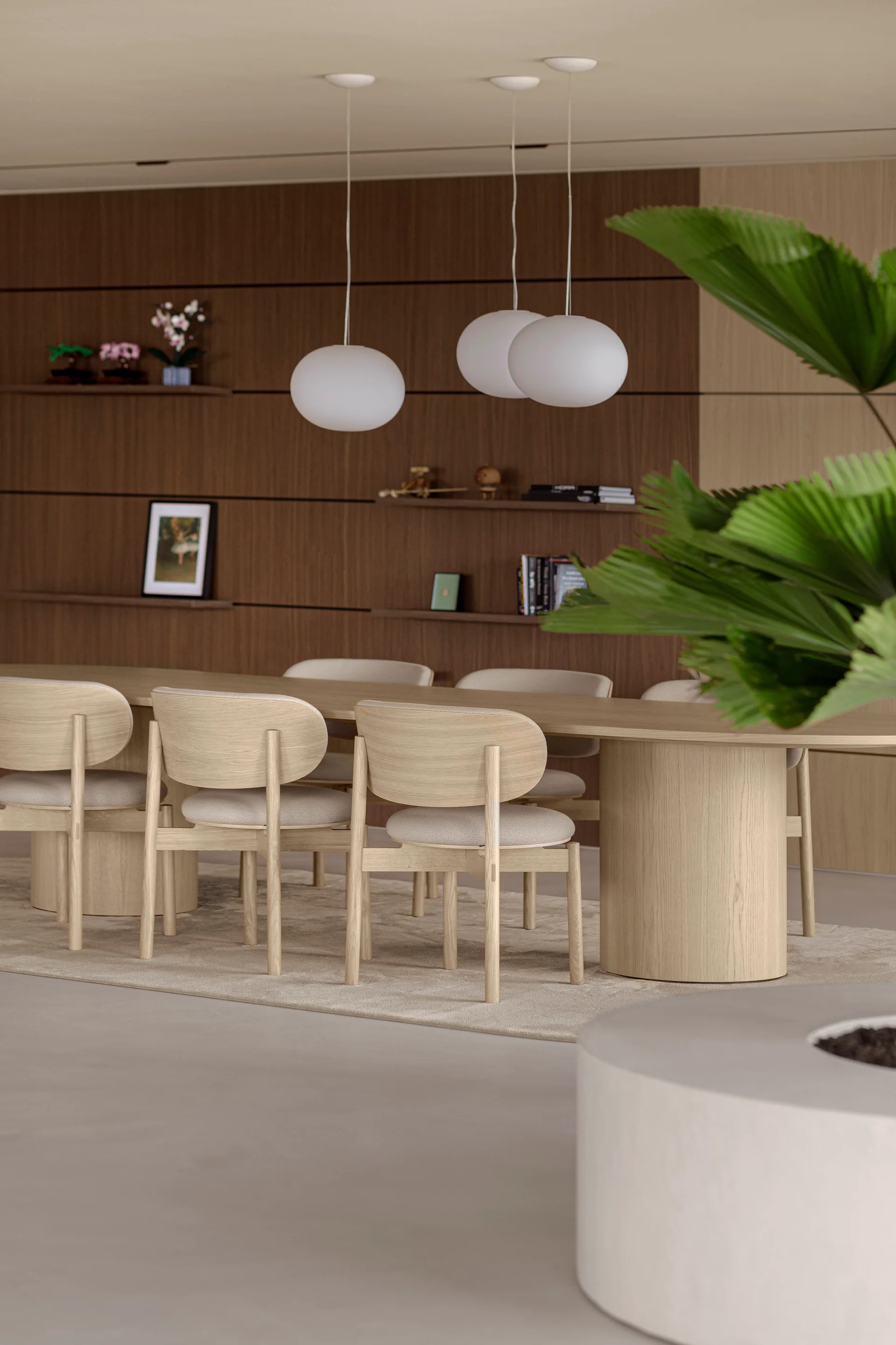A light wood dining table with matching chairs sits beneath white globe pendant lights in front of a dark wood paneled wall with shelves.