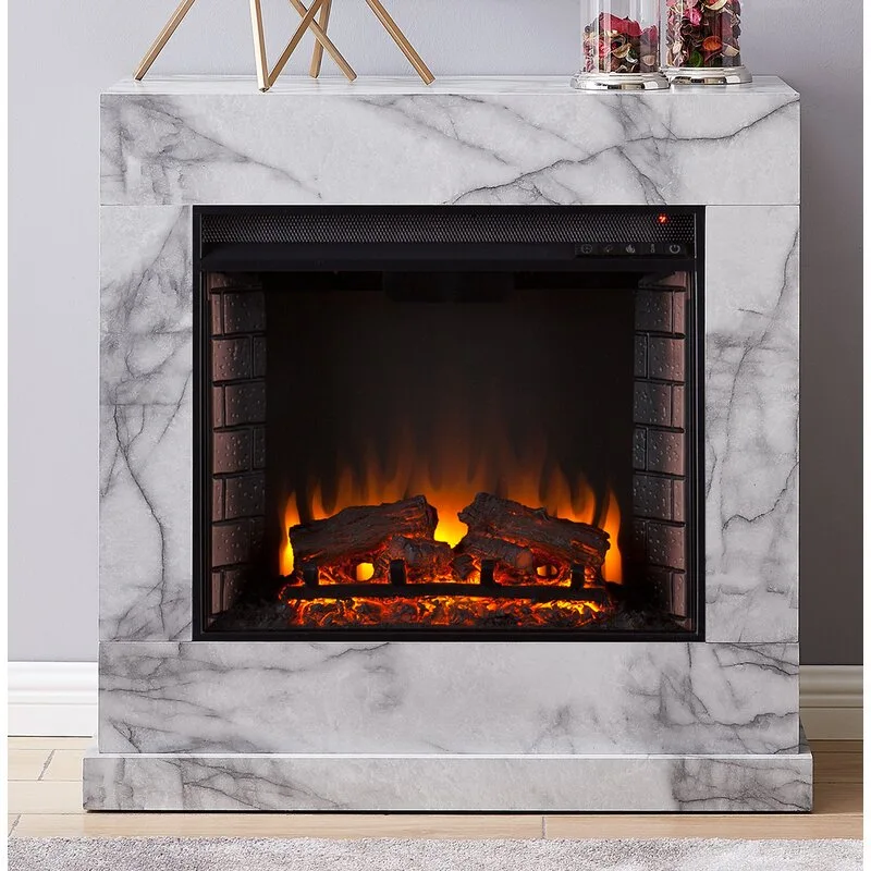 An electric fireplace with a faux white and grey marble mantel stands against a light grey wall next to wood flooring.