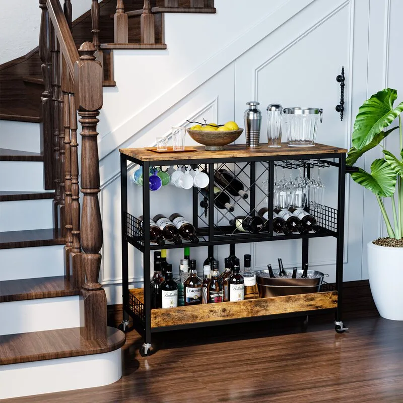 A three-tier industrial bar cart with a black metal frame and wood shelves sits next to a dark wood staircase against a white paneled wall.