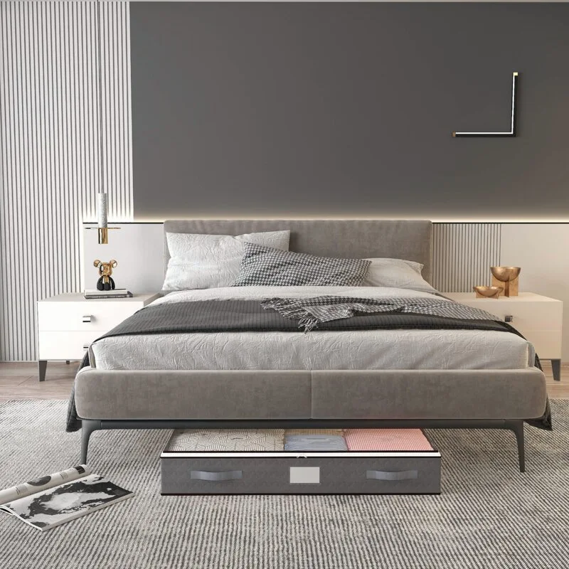 A modern bedroom features a grey upholstered bed, matching textured rug, slatted wall panels, and a grey storage organizer underneath.