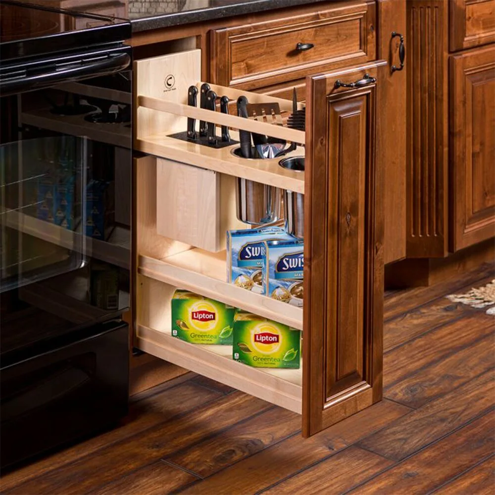 A wooden kitchen cabinet organizer is pulled open to show a knife block, steel canisters holding cooking utensils, and boxed tea.