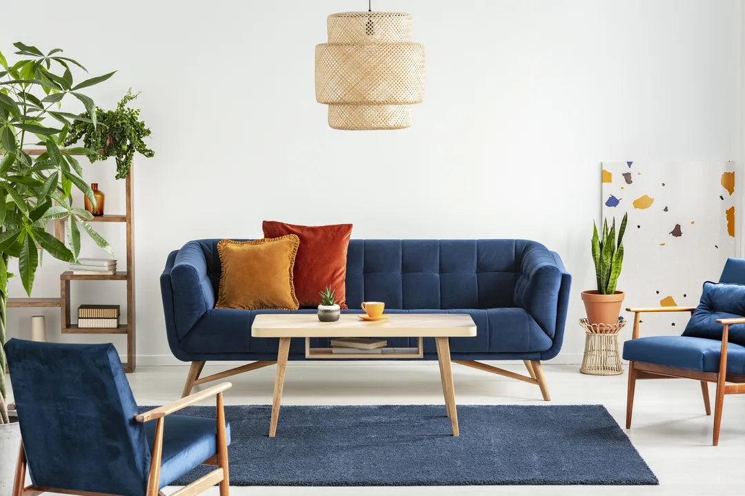Blue wooden armchairs and couch in living room