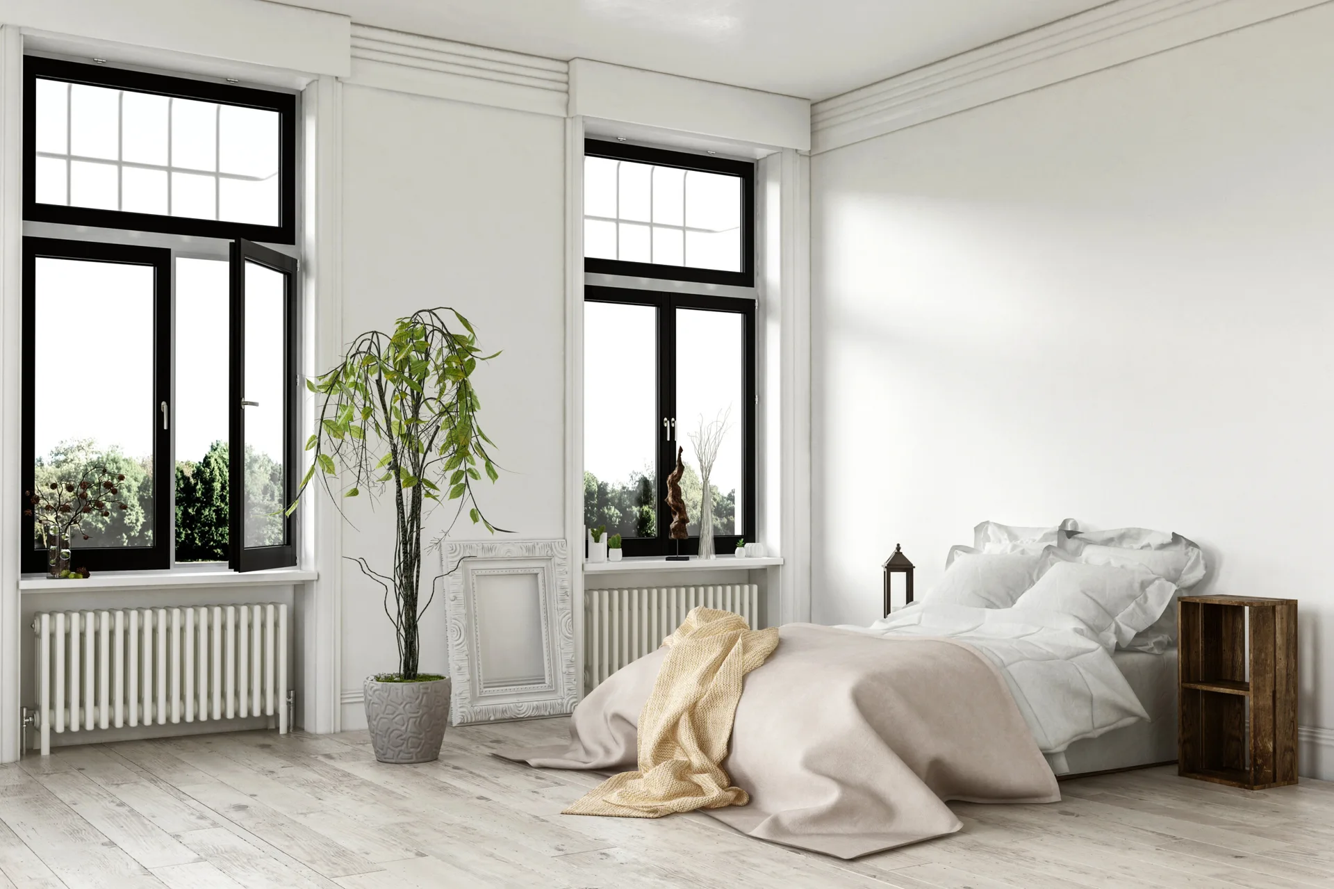 A minimalist white bedroom with a low bed, black-framed windows, a potted plant, and light wood flooring.