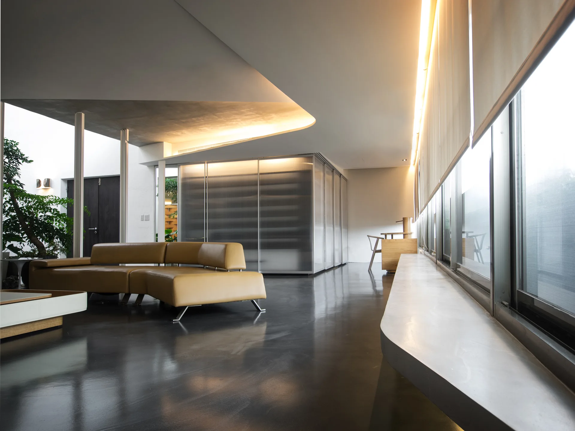 A modern living room features a yellow leather modular sofa on dark glossy floors beneath a curved architectural ceiling with built-in cove lighting.