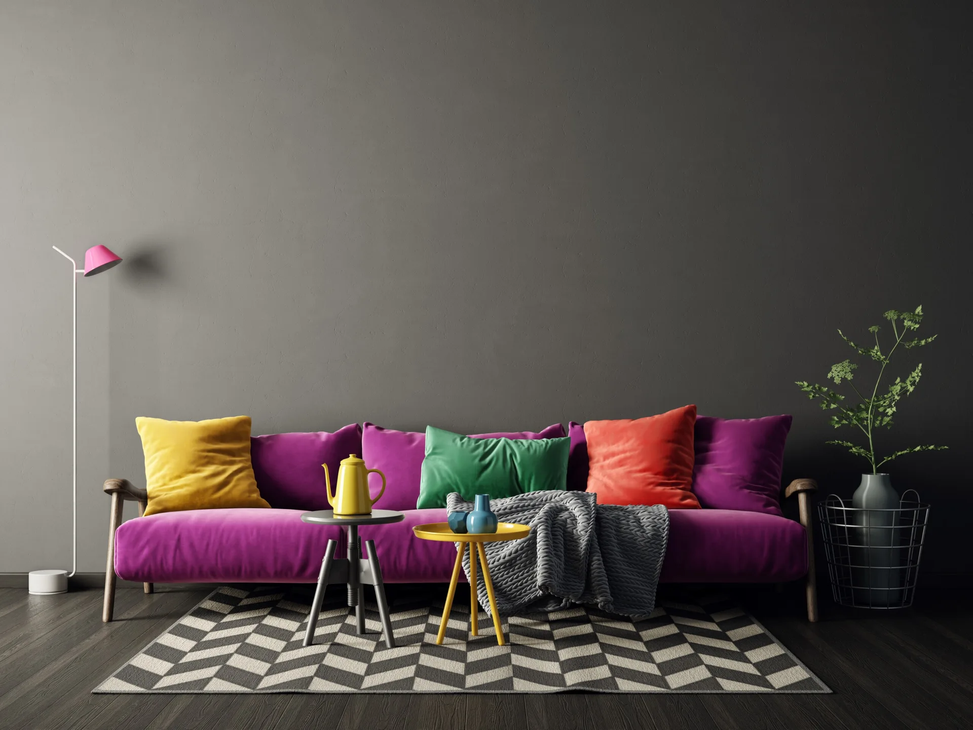 A vibrant purple sofa with colorful cushions sits against a dark gray wall, resting on a black and white chevron patterned rug.