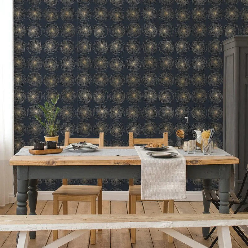A wooden dining table and matching chairs are set in front of a dark blue wall featuring a repeating gold starburst pattern.
