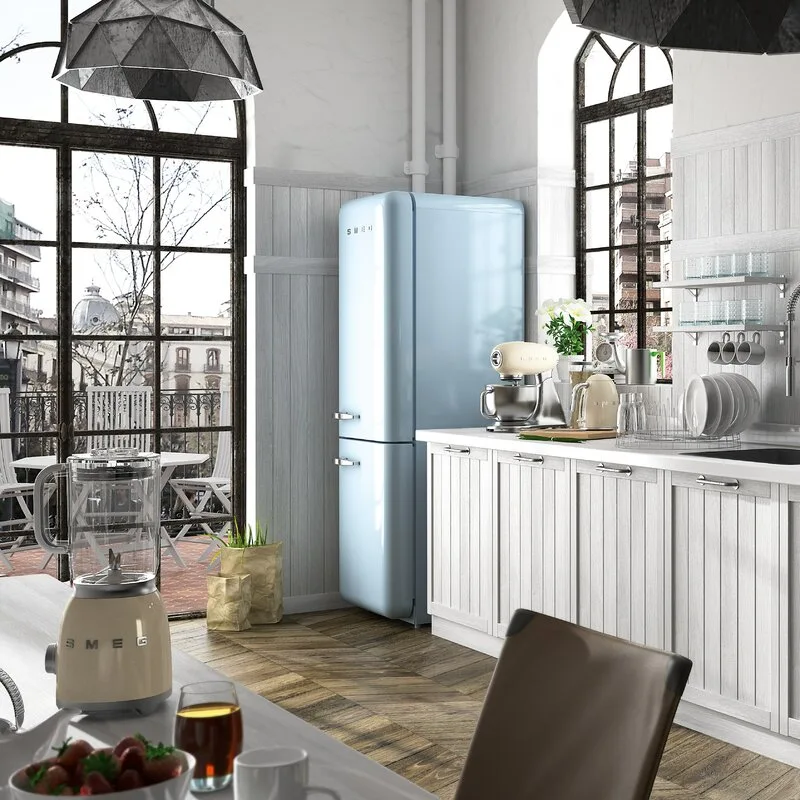 A white paneled kitchen features a light blue retro refrigerator, cream appliances, a herringbone wood floor, and large black-framed arched windows.