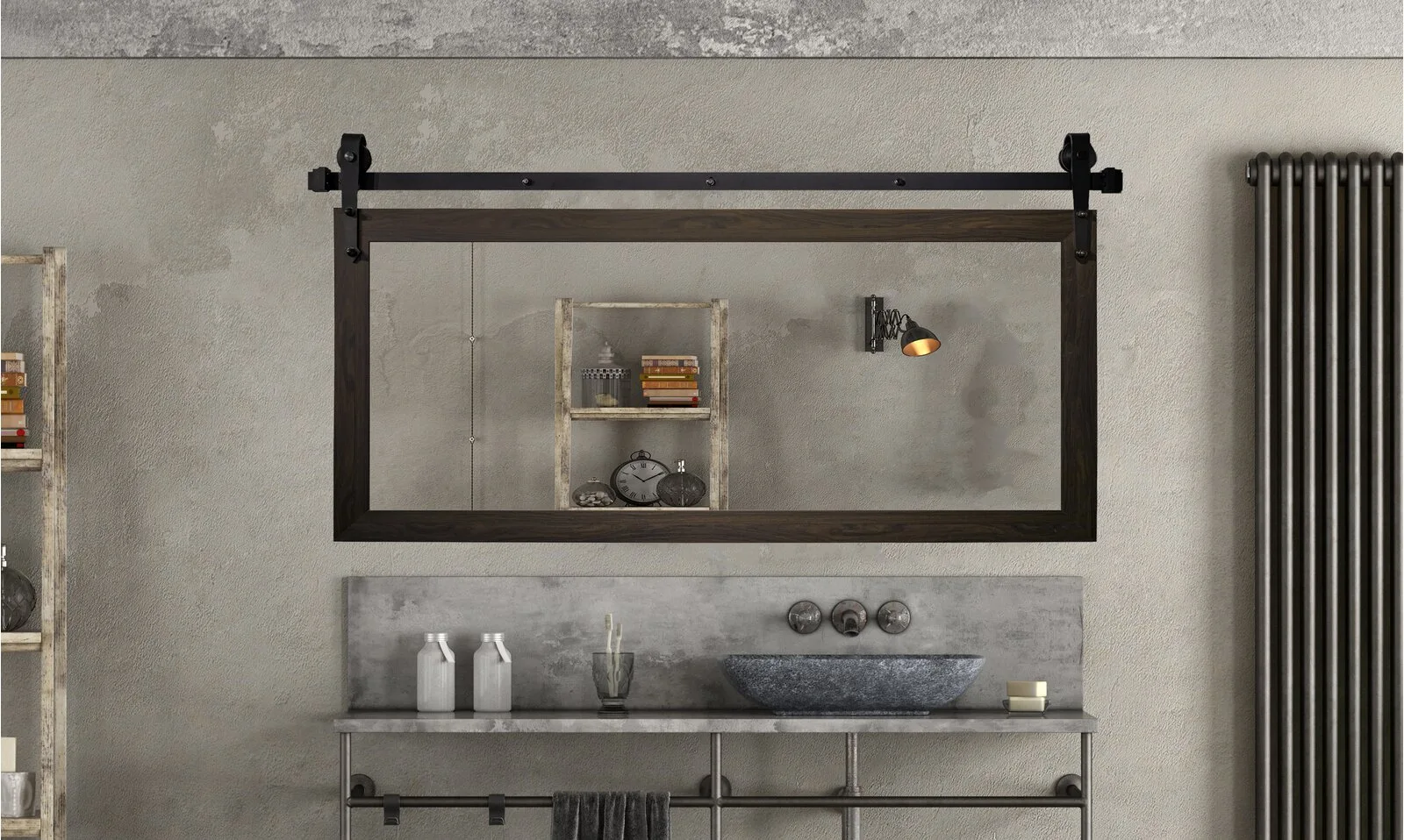 An industrial bathroom vanity features a stone vessel sink beneath a large wood-framed mirror suspended from a black sliding barn door track.