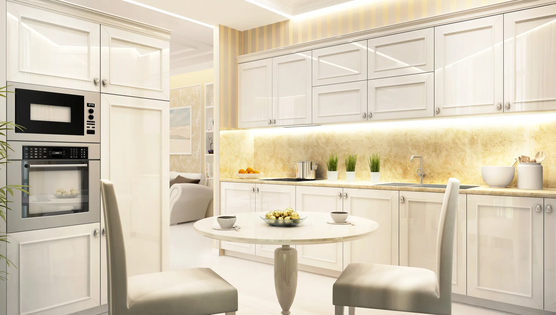 A bright kitchen features glossy white shaker cabinets, a gold-toned stone backsplash with integrated lighting, and a small round pedestal dining table.