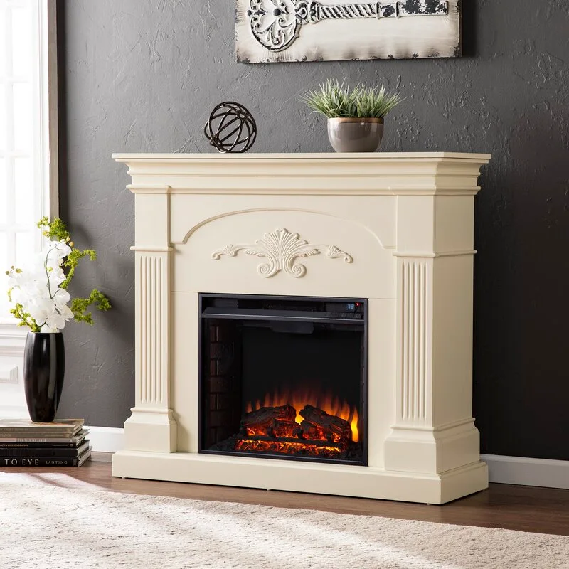 A cream-colored electric fireplace with fluted columns stands against a textured charcoal wall on a light-colored rug.
