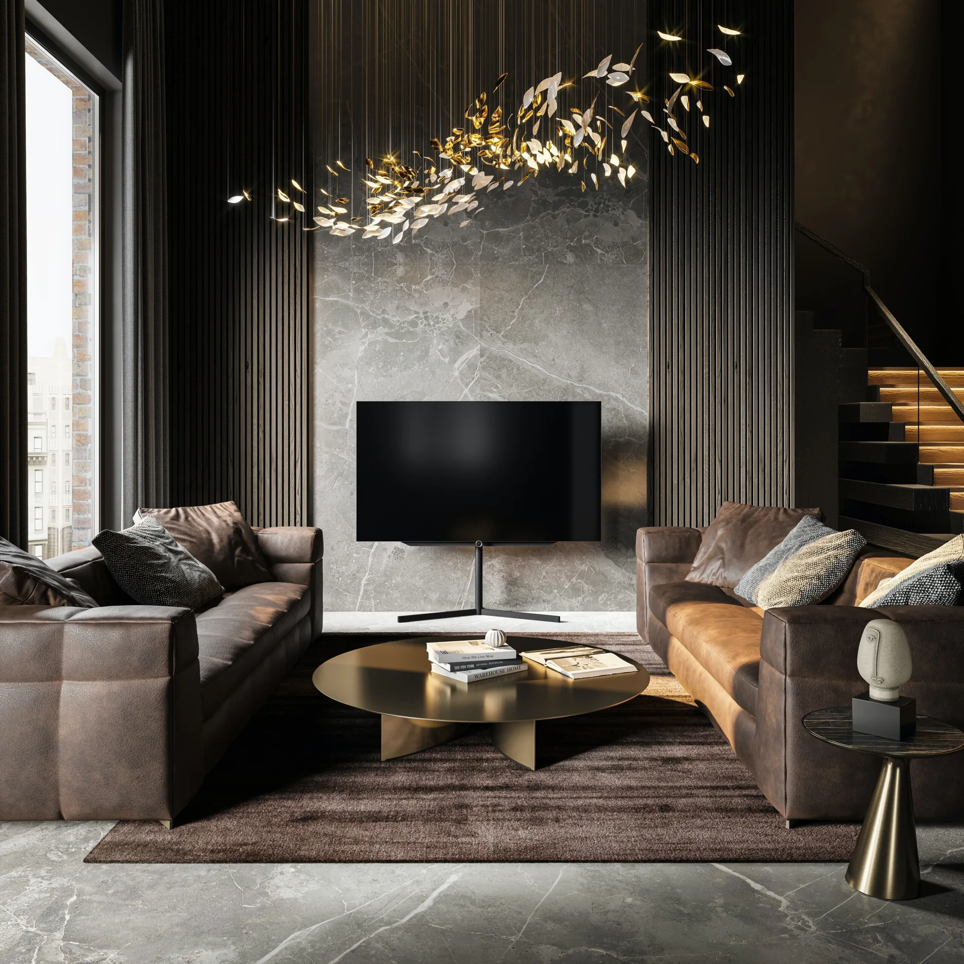 Two brown leather sofas face each other around a brass coffee table in a room with a marble feature wall and a golden sculptural chandelier.
