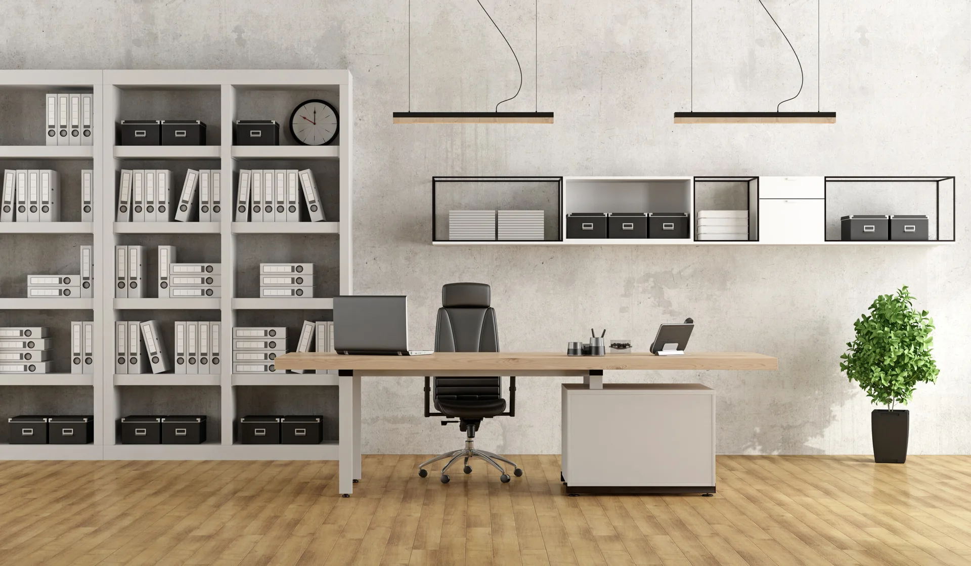 A minimalist home office featuring a wooden desk, black office chair, concrete textured wall, and white bookshelves filled with organized folders.