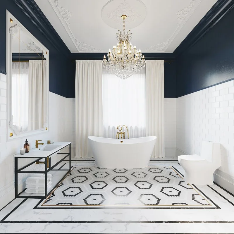 A symmetrical bathroom with a freestanding white tub centered on geometric floor tiles under a large crystal chandelier.