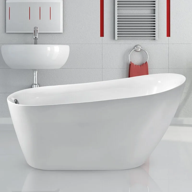 A modern white freestanding oval bathtub sits in a bathroom with a wall-mounted sink, grey wall tiles, and a red hand towel on a ring.