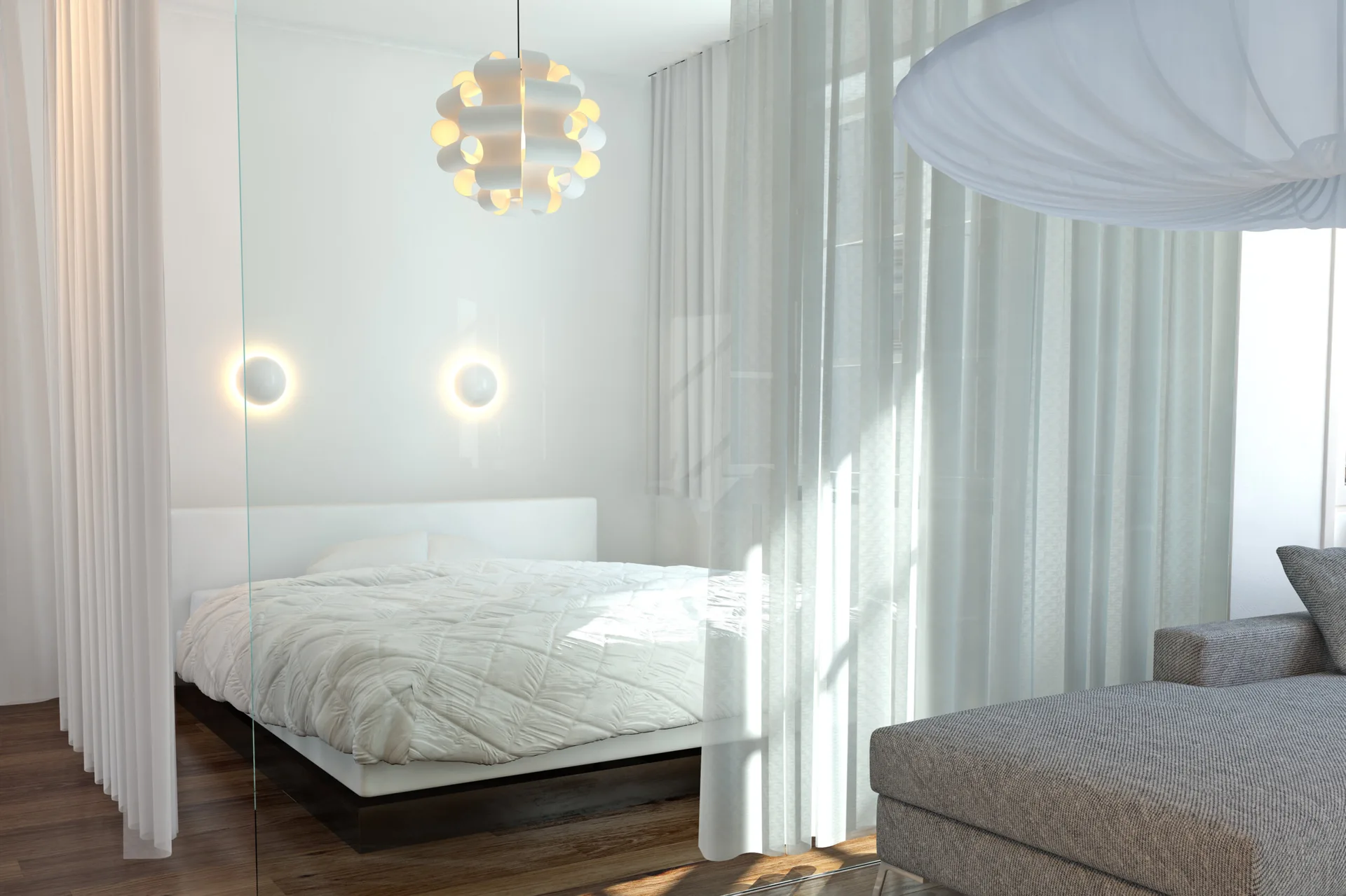 A minimalist white bedroom featuring a platform bed and sculptural light fixtures separated from a gray sofa by a sheer white curtain partition.