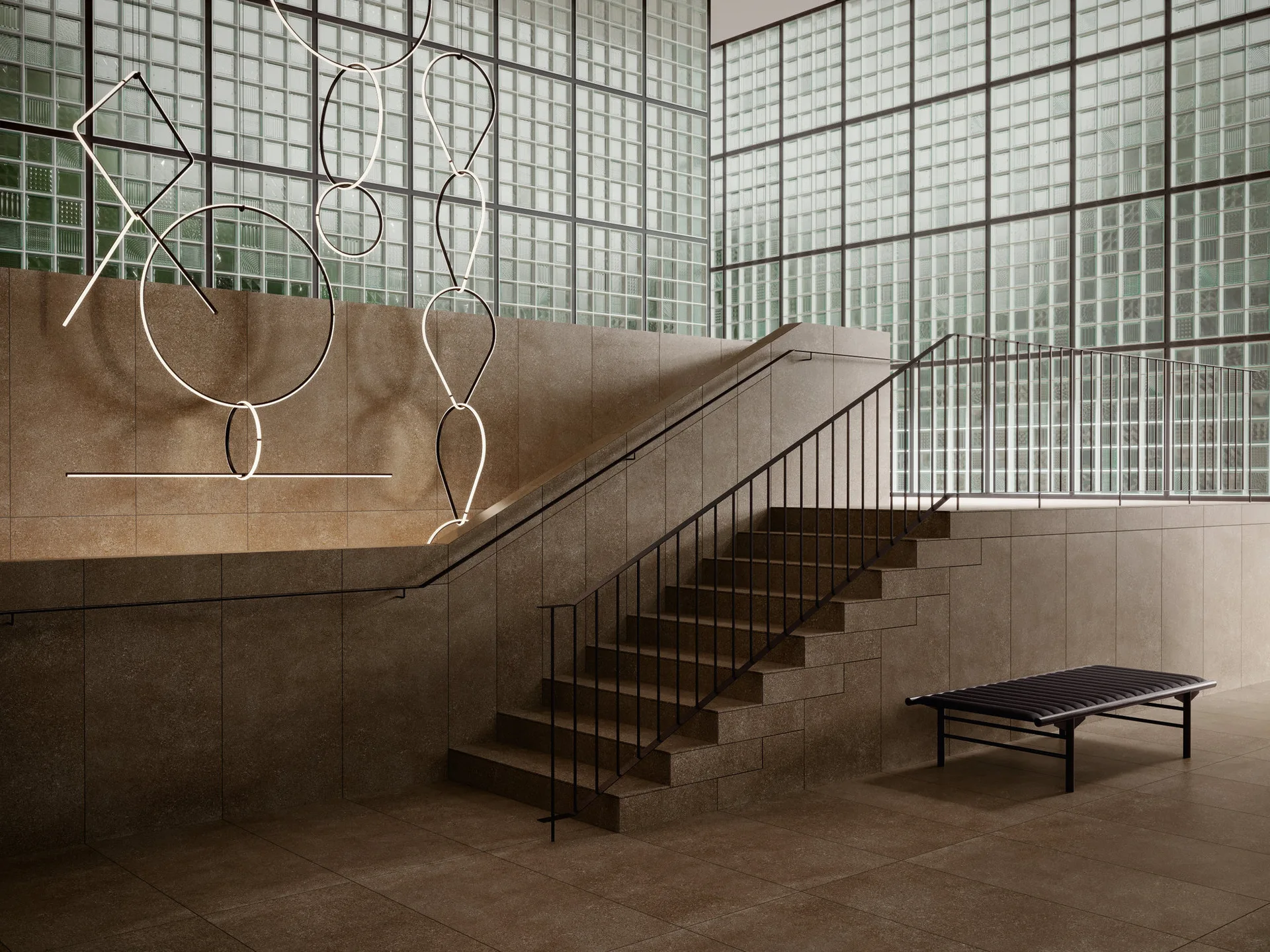 A brown stone staircase with a black metal railing features a large glass block wall background and delicate glowing geometric light fixtures.